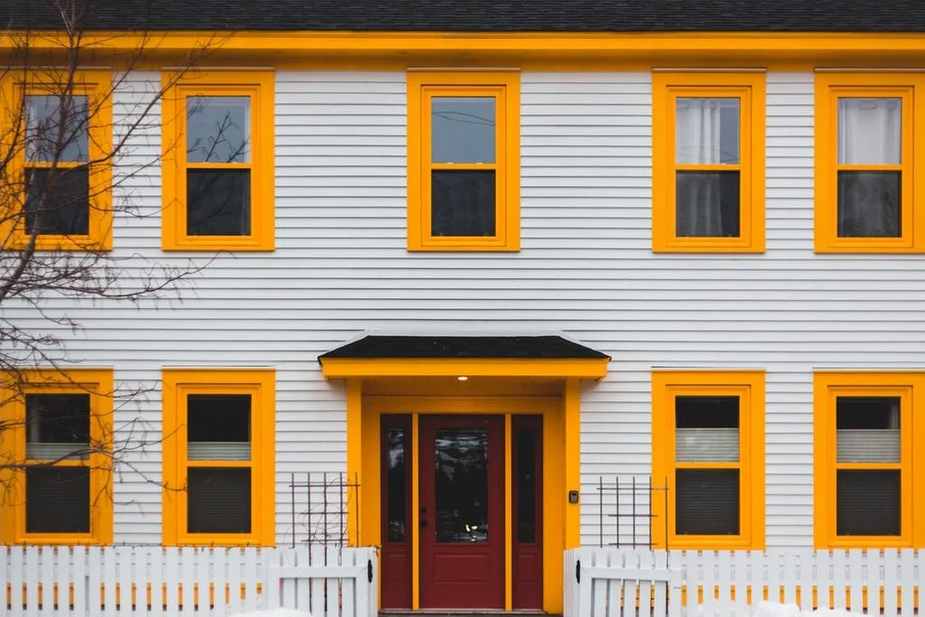 Balancing with Yellow in gray house exterior