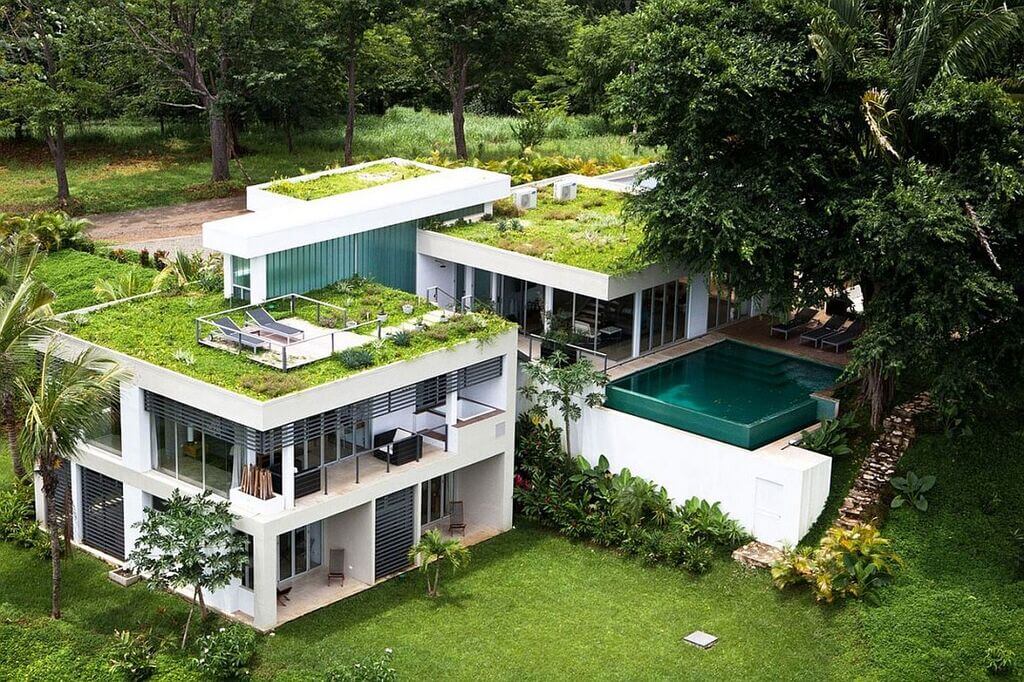 An aerial view of a house with a green roof
