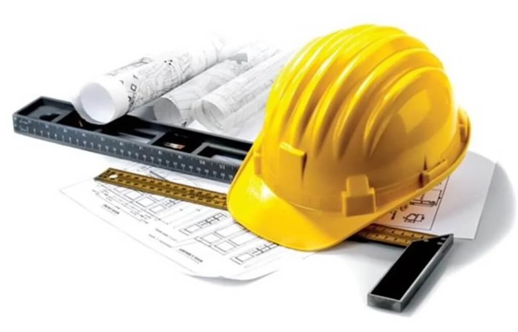 A hard hat, ruler, and other construction equipment
