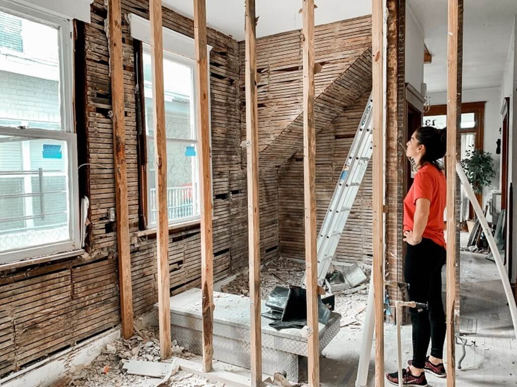 A woman standing in a room that is being renovated

