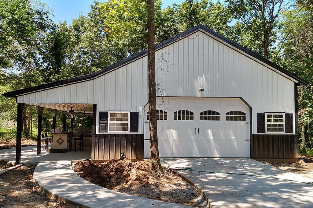 A white garage with black shutters on the front of it
