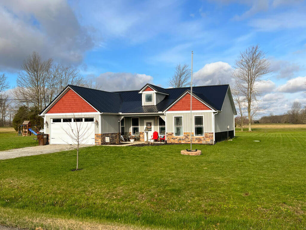 A red and white house with a blue roof
