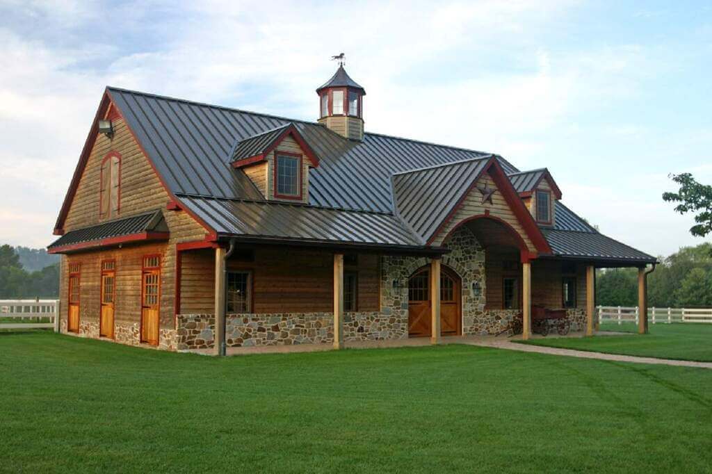 A large wooden Barn with a metal roof
