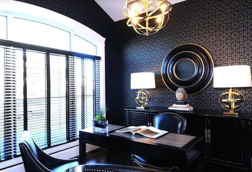 A black and white room with a desk and chairs
