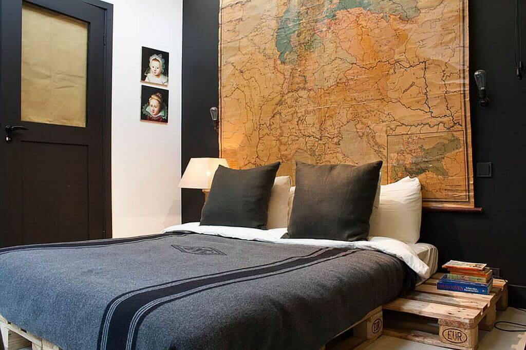 A bedroom with a large map on the wall
