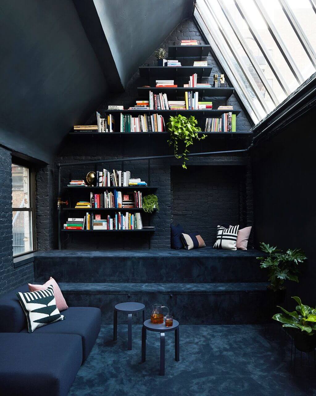 A living room with a couch and a book shelf
