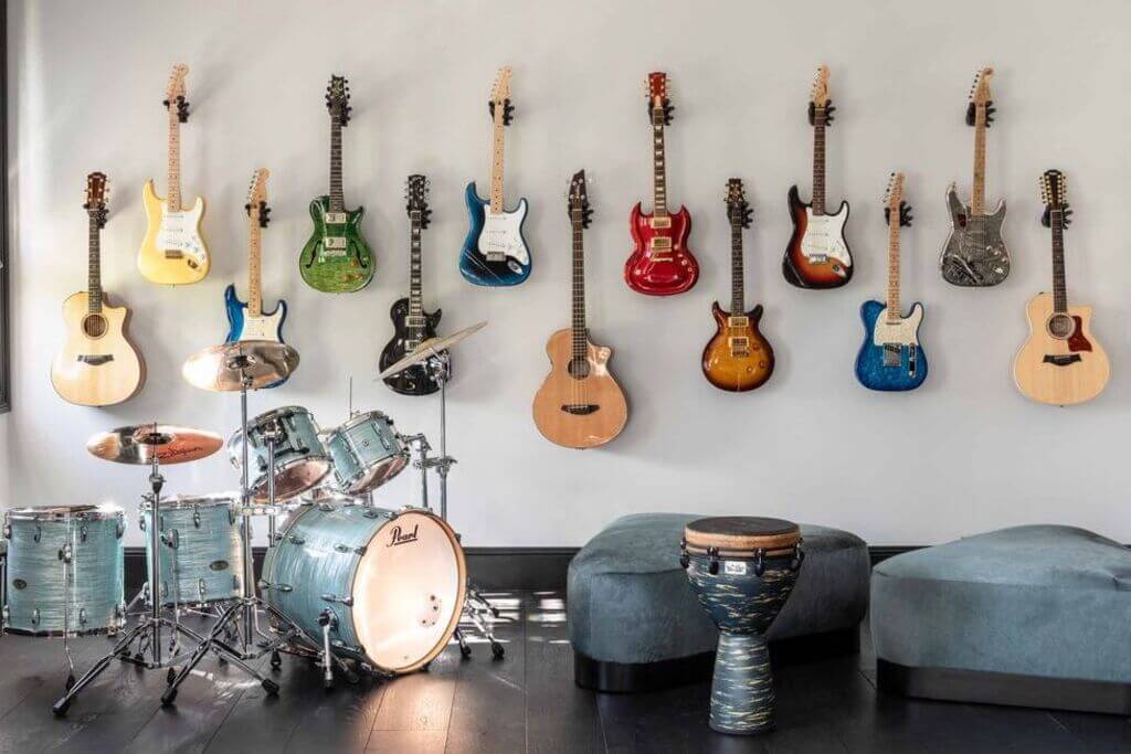 A room with guitars hanging on the wall
