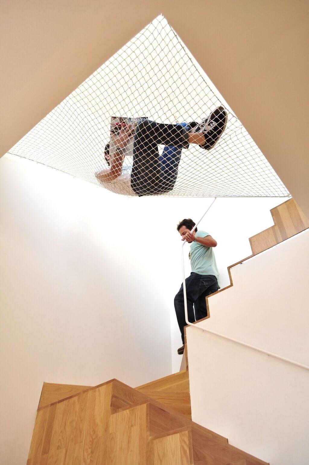 A man riding a skateboard down a wooden stair case
