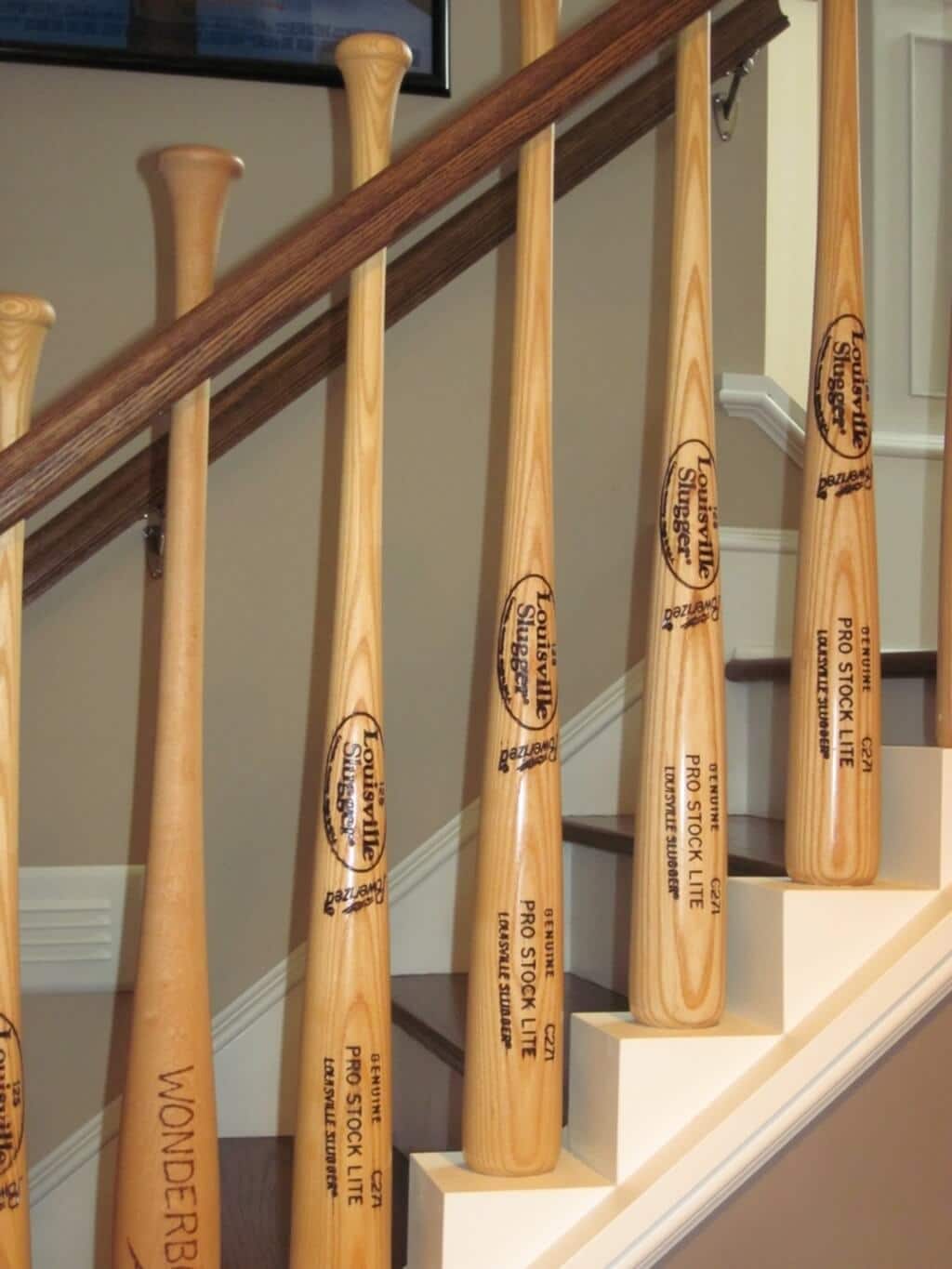 A group of wooden baseball bats sitting on top of a set of stairs
