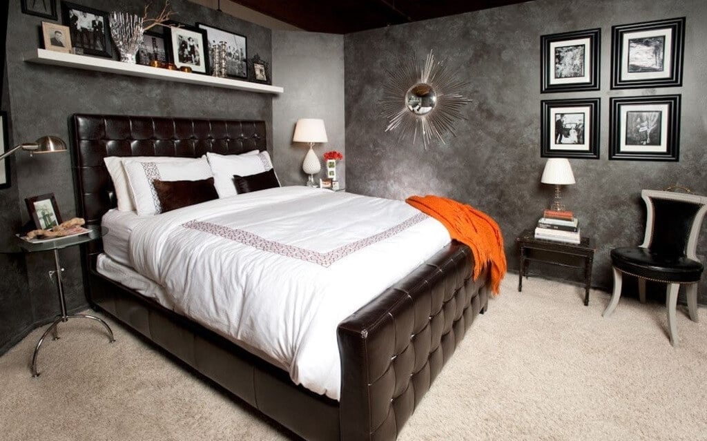 A bedroom with a large bed and pictures on the wall
