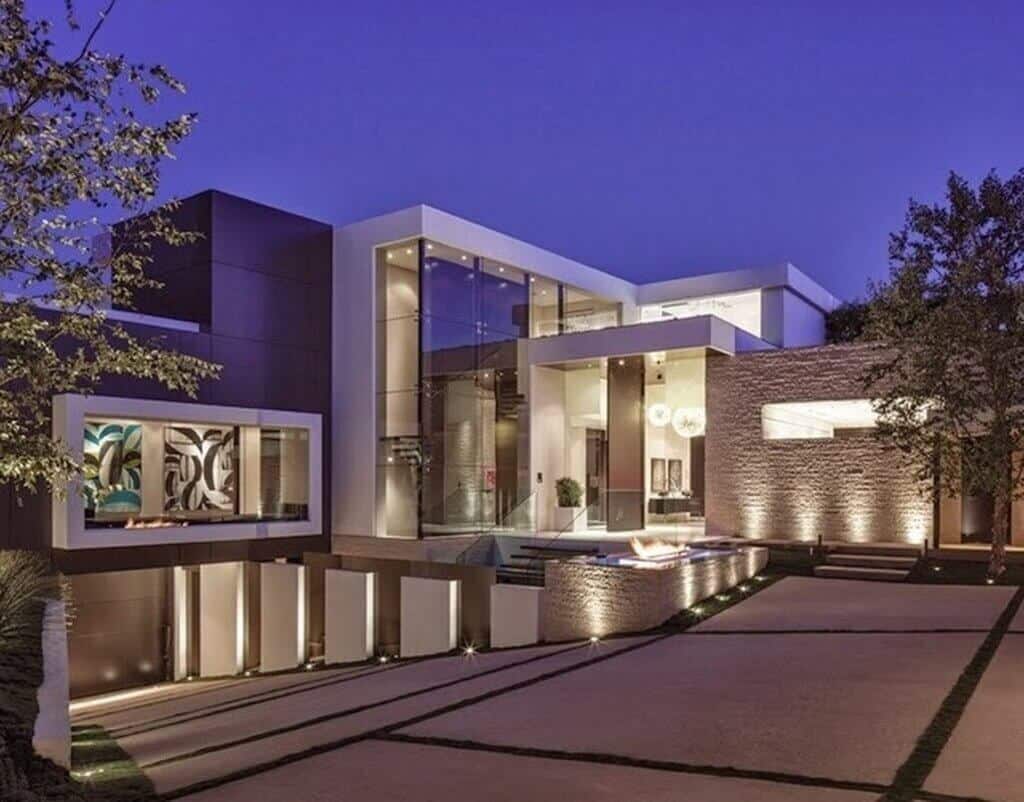 A large modern house with a lot of windows
