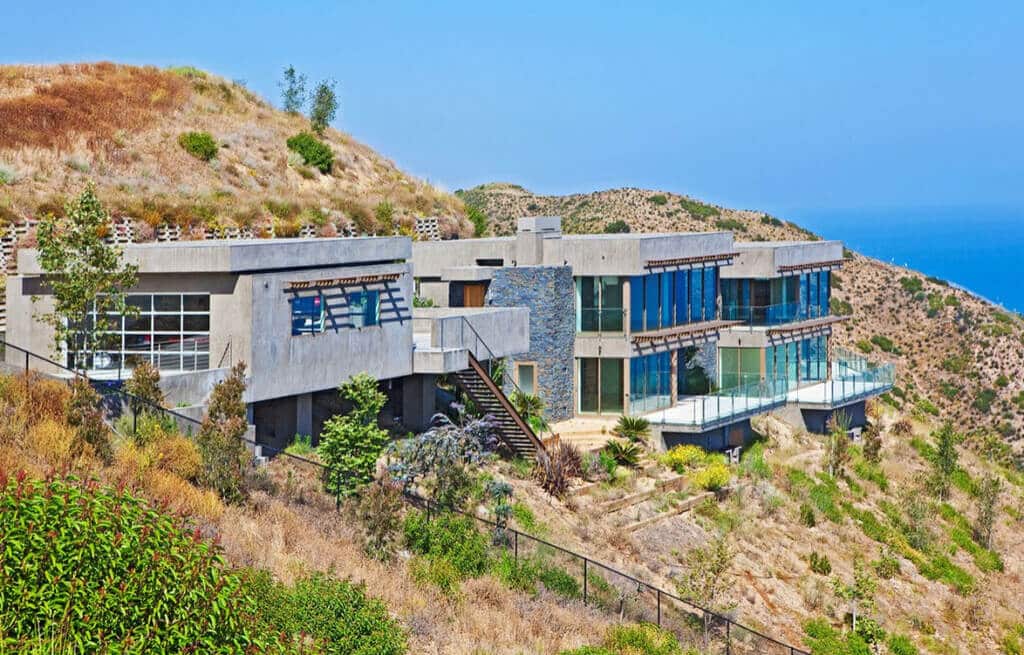 A house on a hill overlooking the ocean
