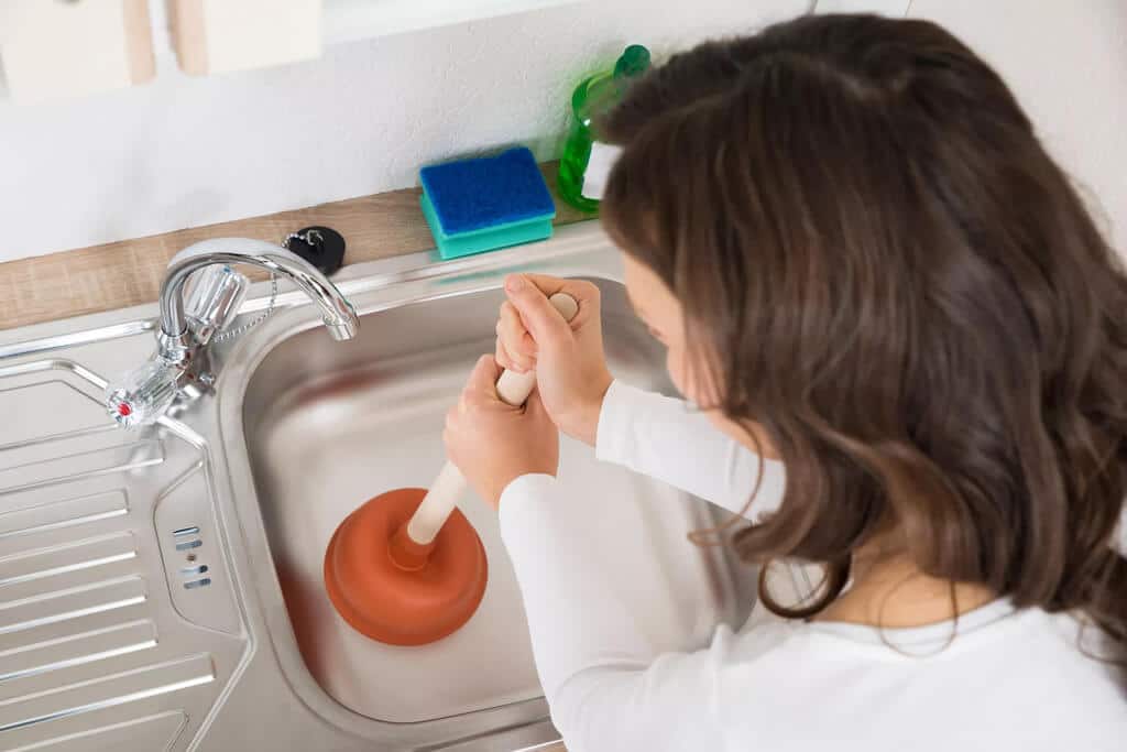 A woman washing her hands in a sink
