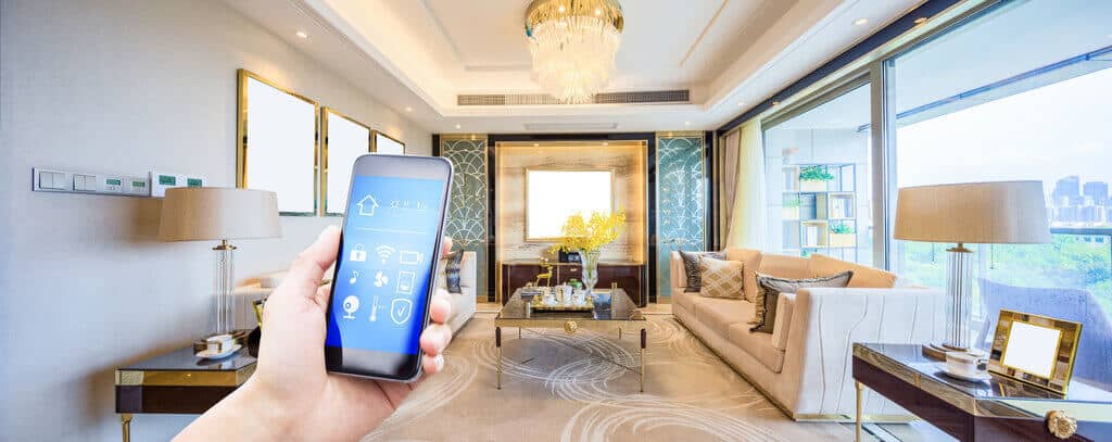 A person holding a smart phone in a living room
