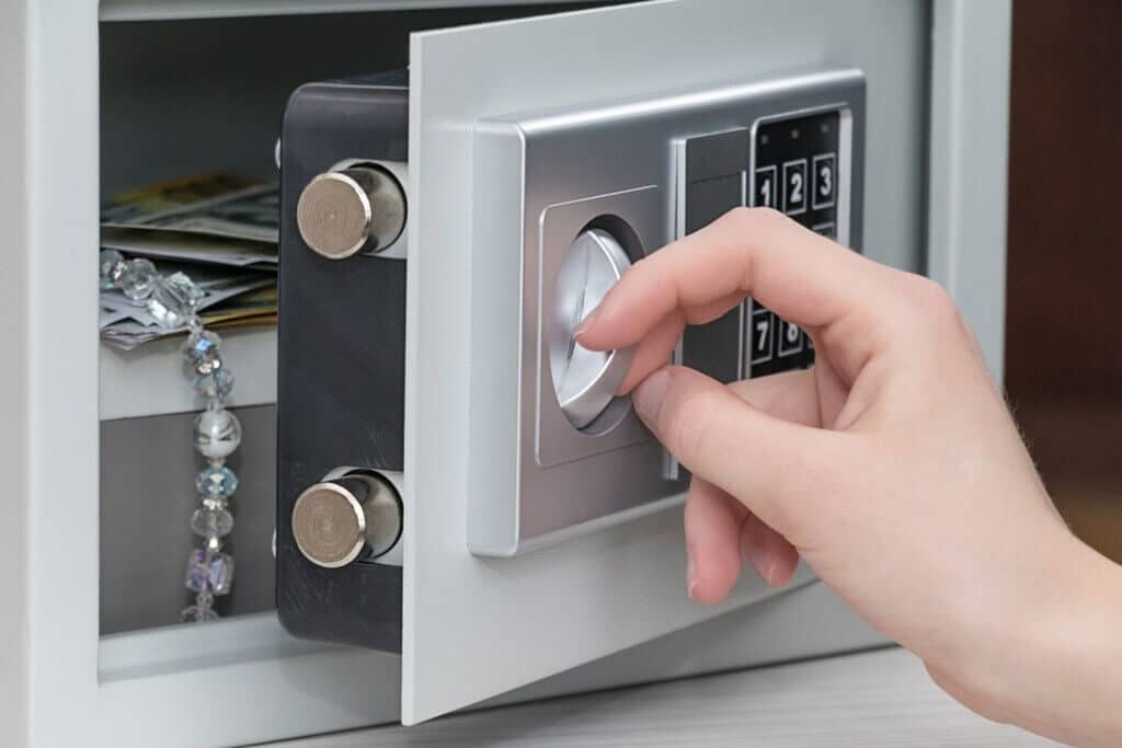 A person is pressing the button on a safe
