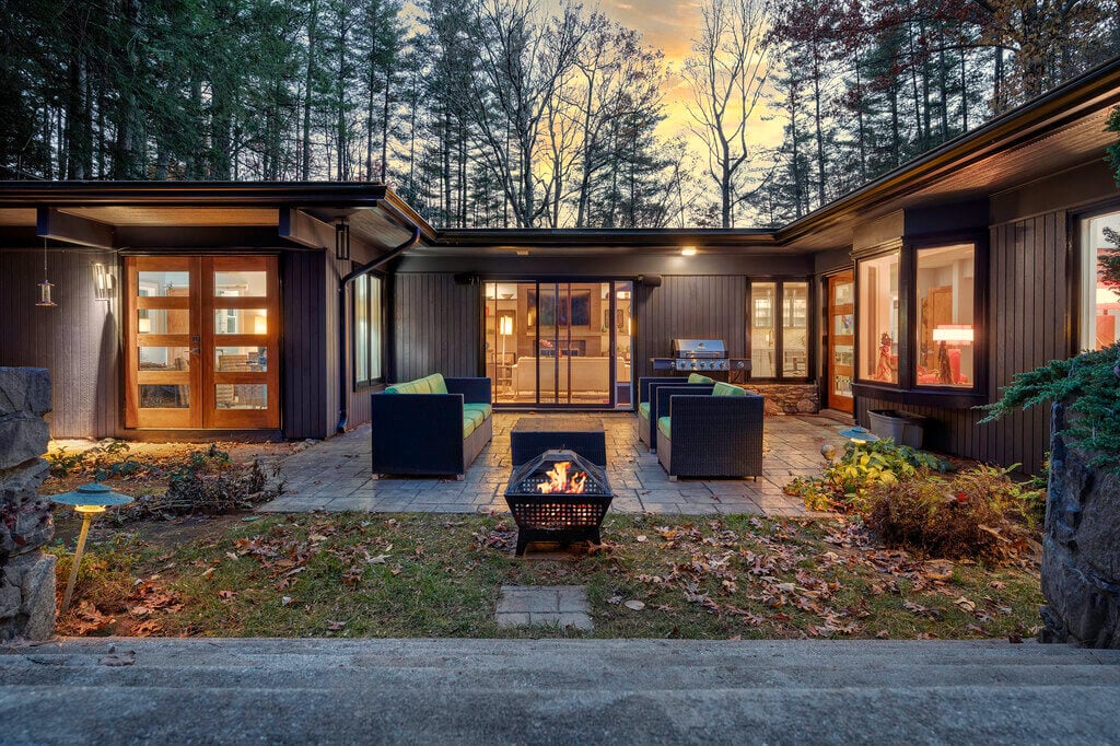 A house with a fire pit in front of it

