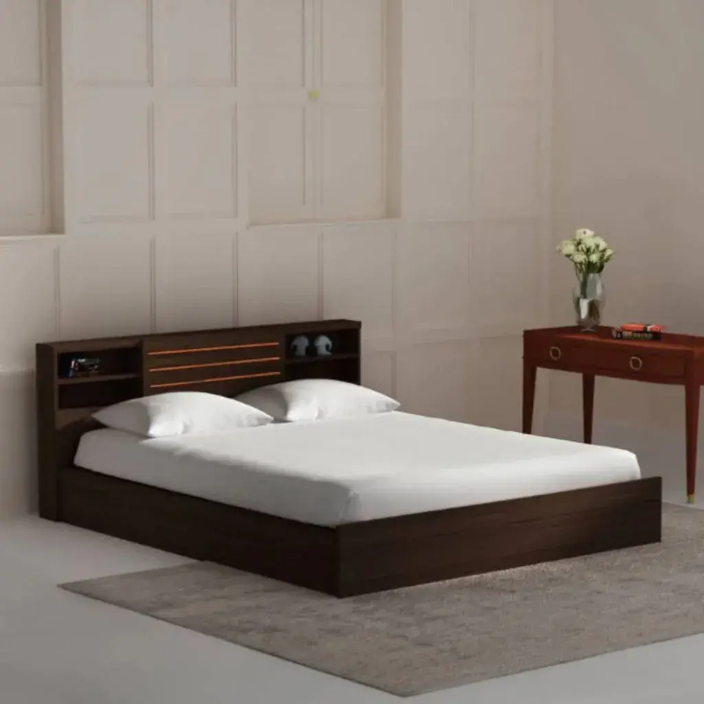 A bed with a wooden headboard and white sheets
