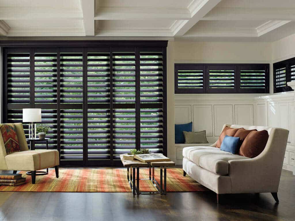 A living room with furniture and Plantation Shutters
