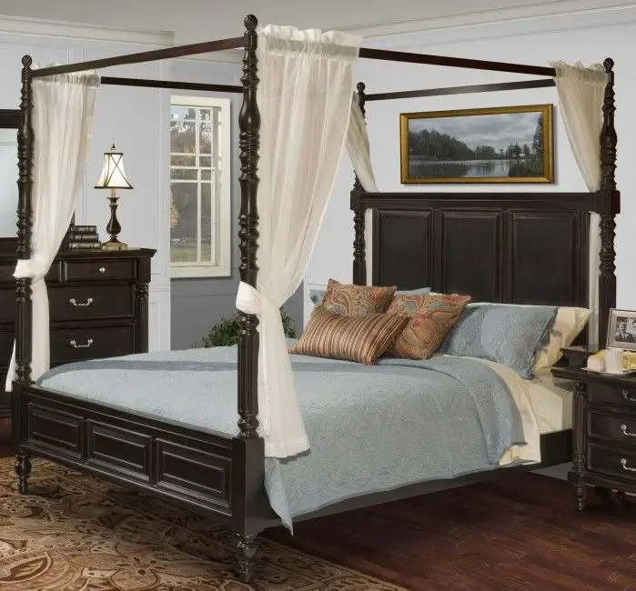 A bedroom with a four poster bed and a dresser
