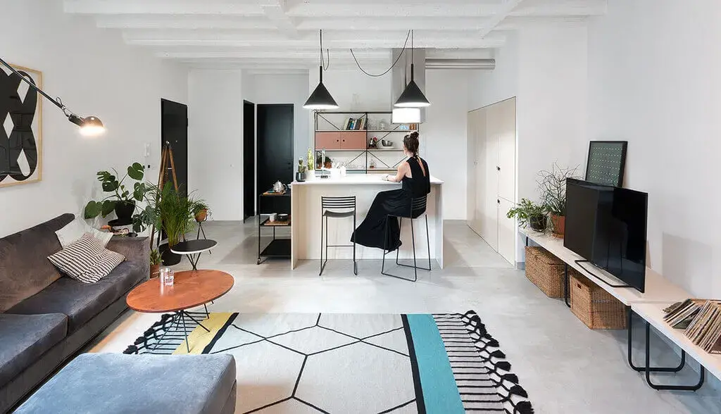 A woman sitting at a table in a living room
