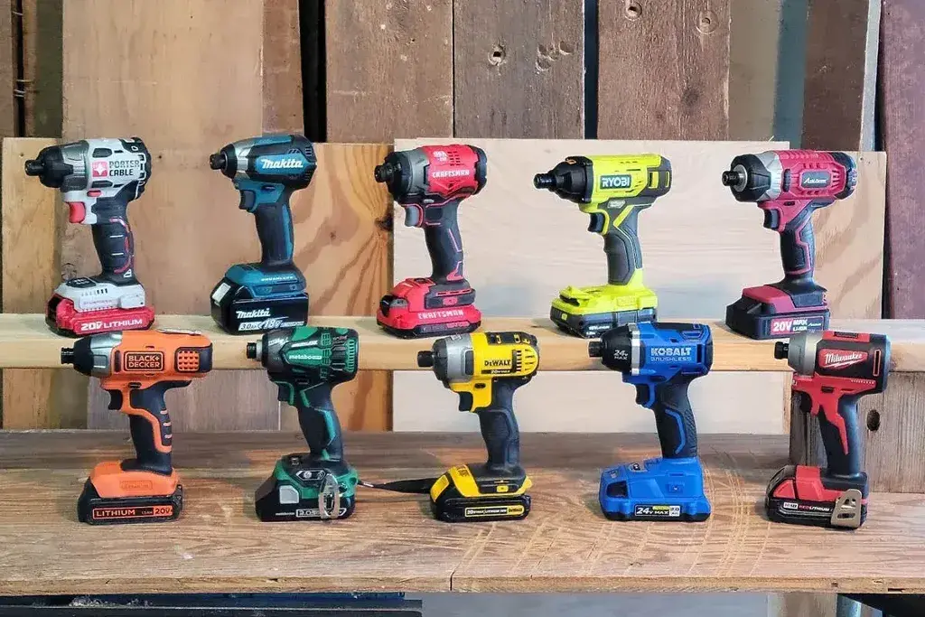 A group of Impact Drivers sitting on top of a wooden table
