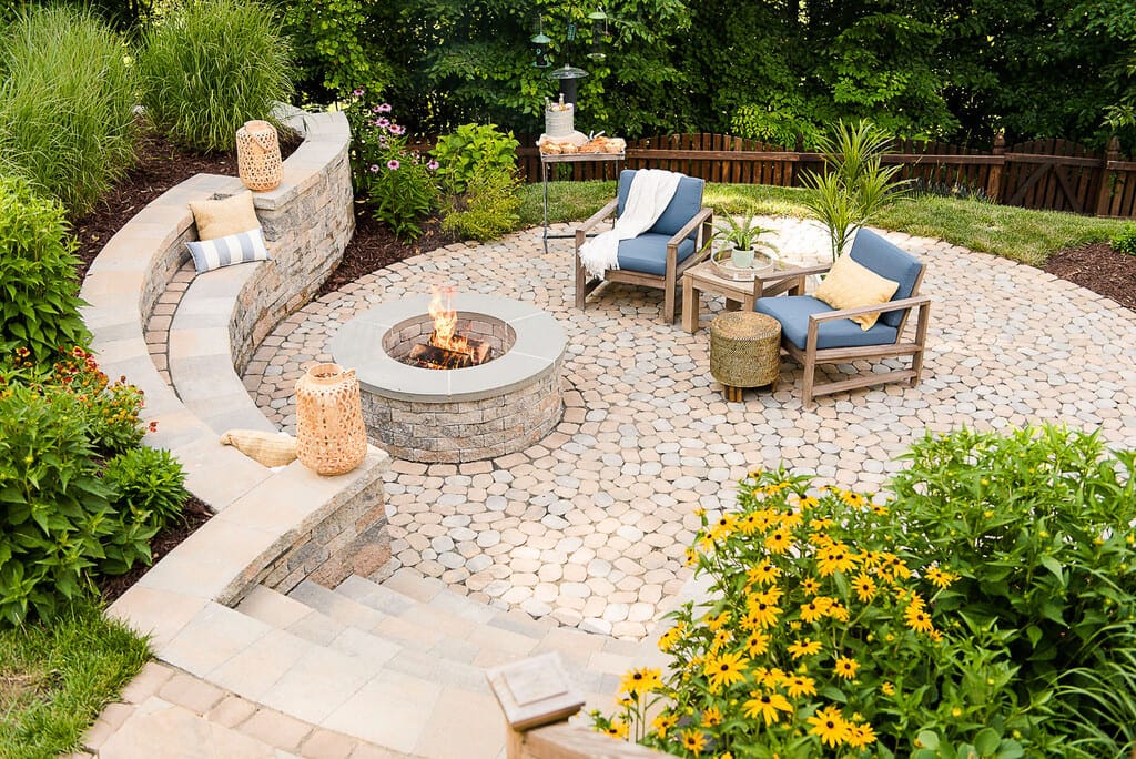 A patio with a fire pit and seating area
with retaining wall idea