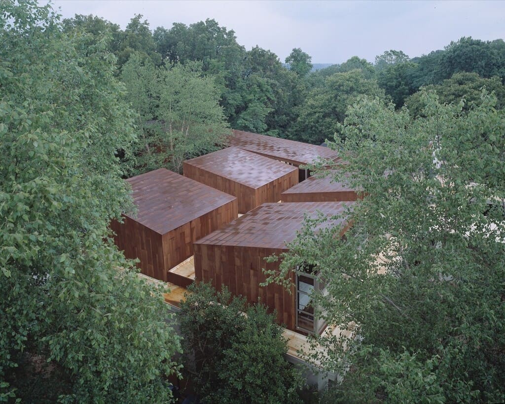 An aerial view of a building surrounded by trees
