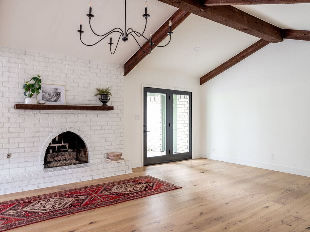 A living room with a fireplace and a rug
