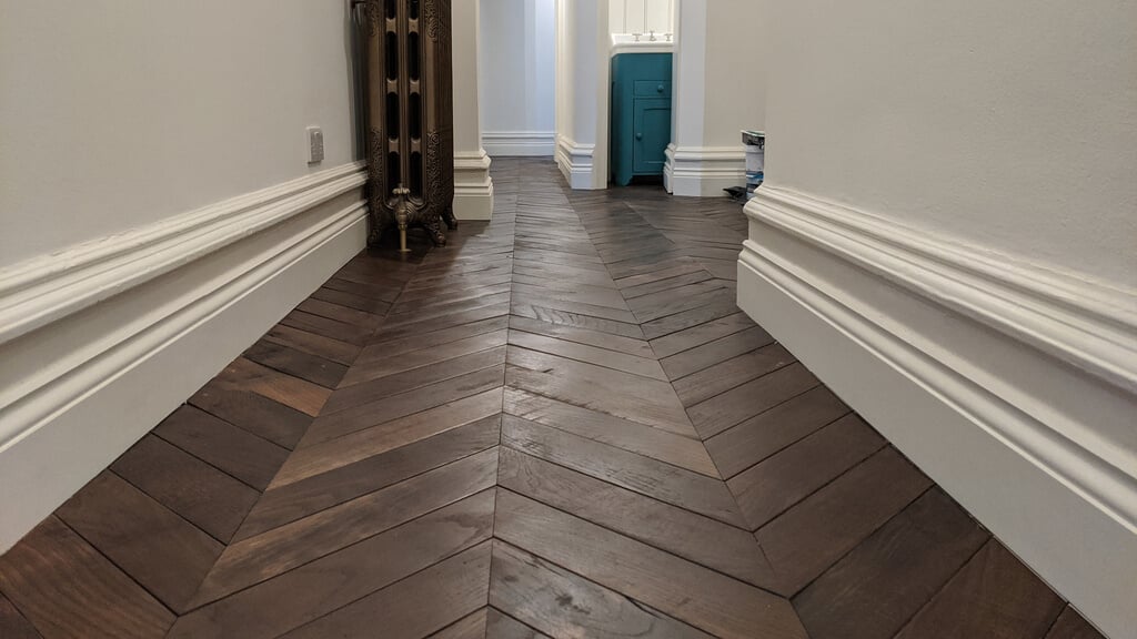 A hallway with a Skirting Boards floor and a radiator

