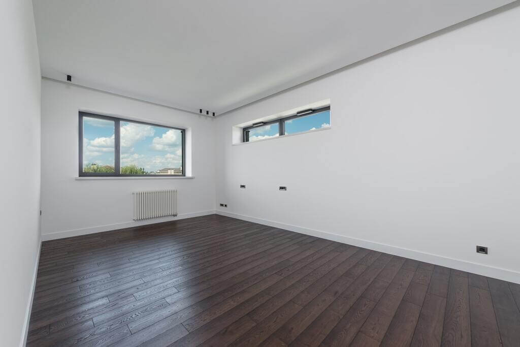 An empty room with a Skirting Boards floor and a radiator
