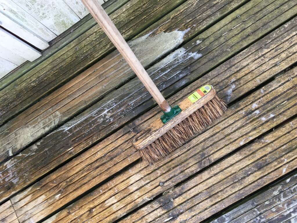 A broom on top of a wooden floor
