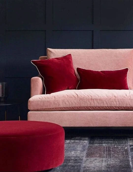 pink sofa with red cushion cover