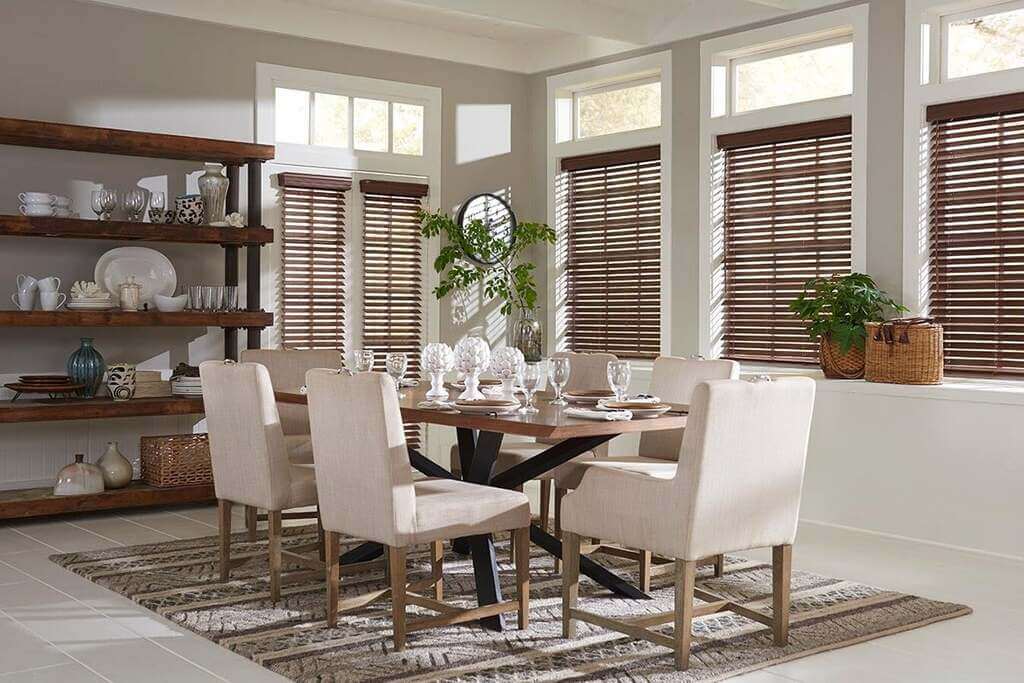 A dining room with a table and chairs
 with  Window Blinds