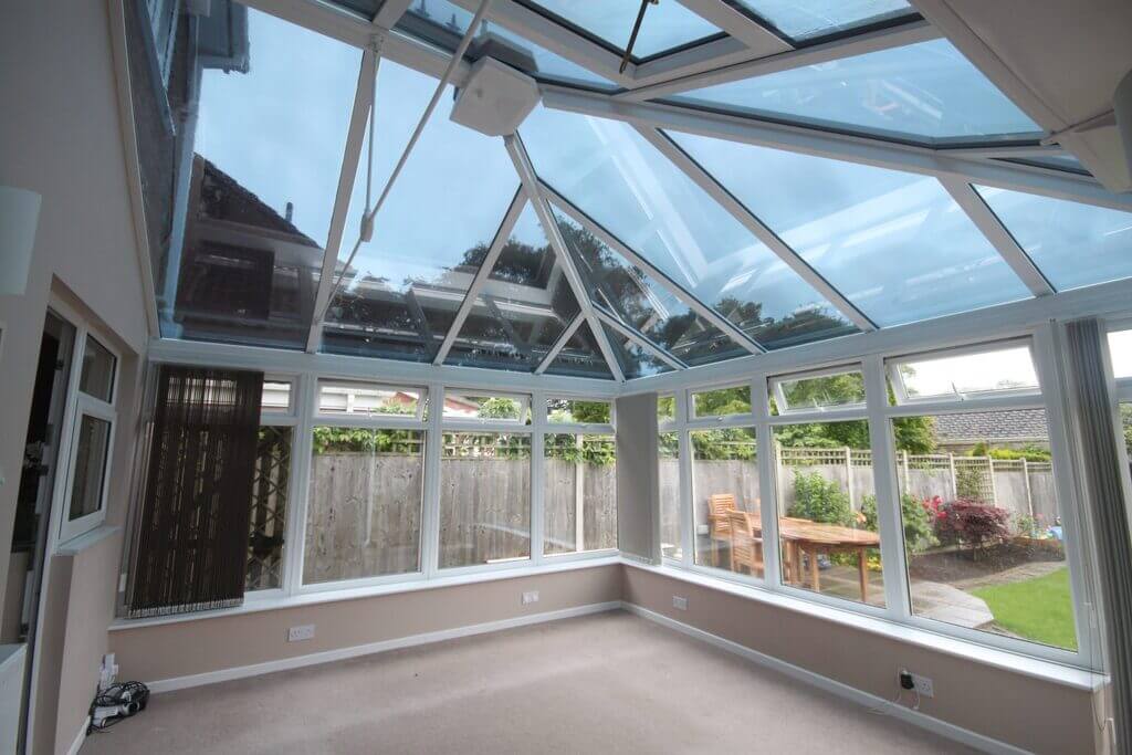 A conservatory in a home with a glass roof.