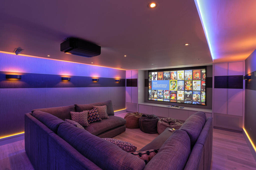A purple couch sitting in a living room next to Projectors for Home Theatres