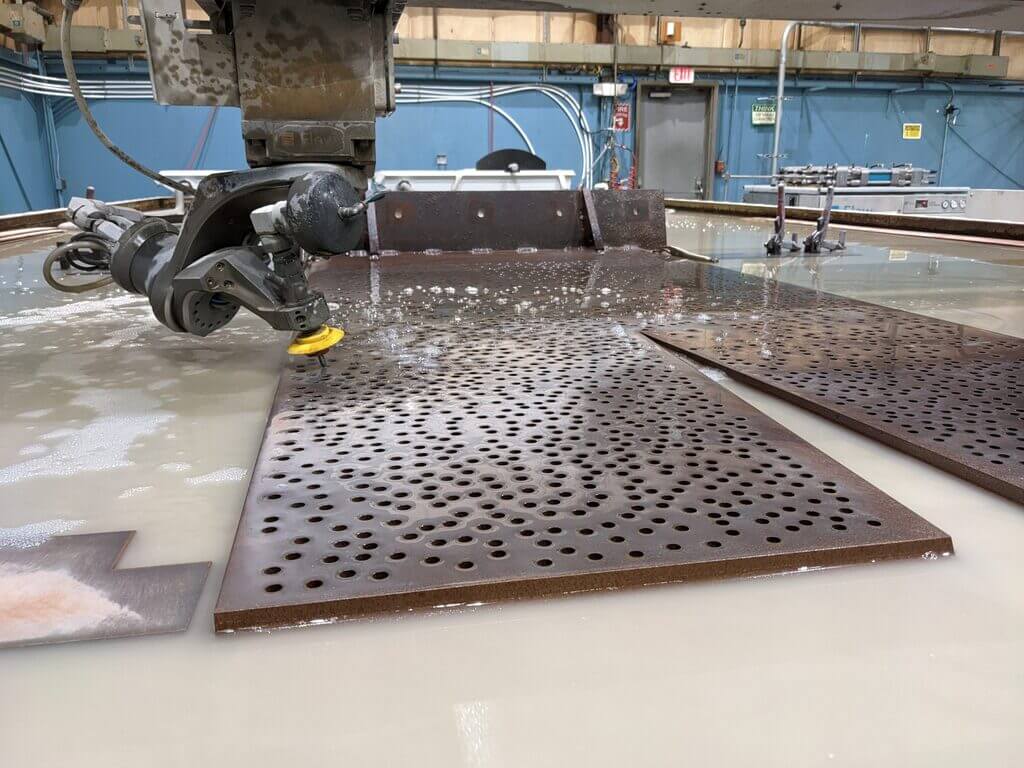 A machine that is cutting a piece of metal
