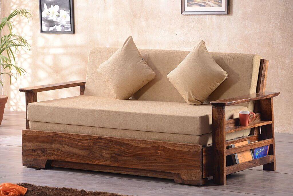 A wooden couch with two pillows on top of it
