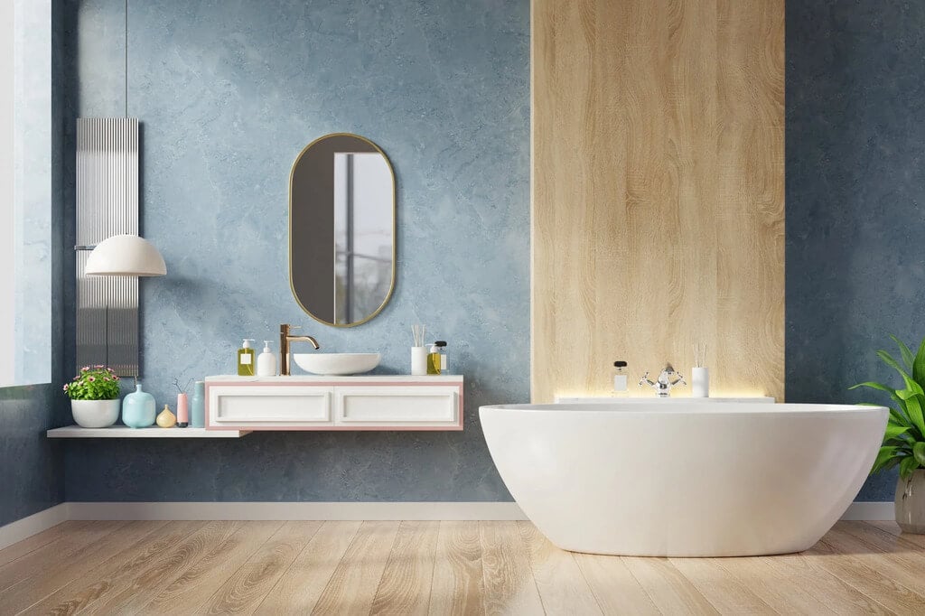A bathroom with a tub, sink and mirror
