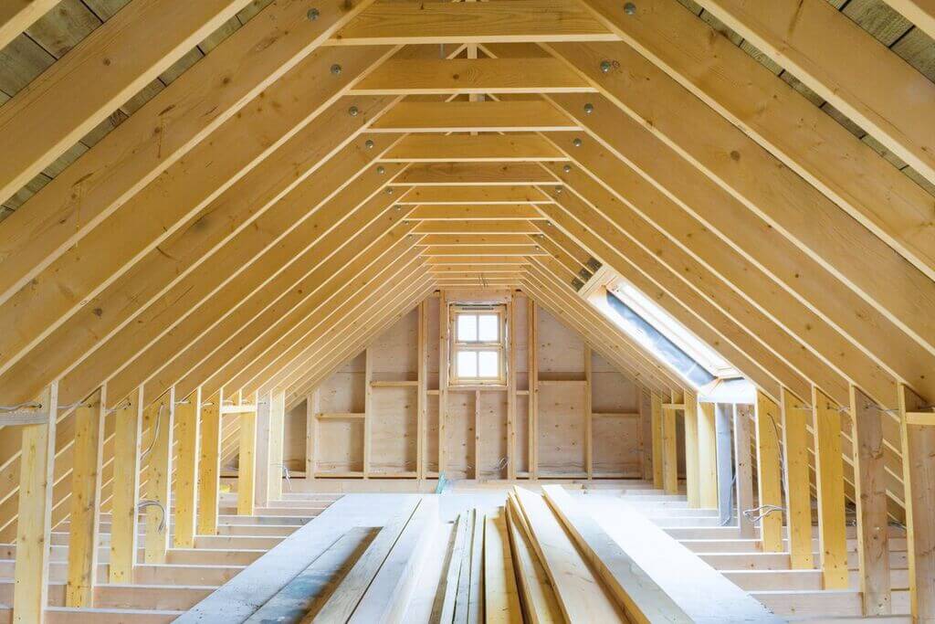 A attic with a lot of wooden beams in it
