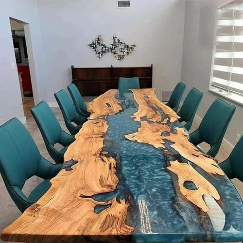 A long table with chairs around it in a room
